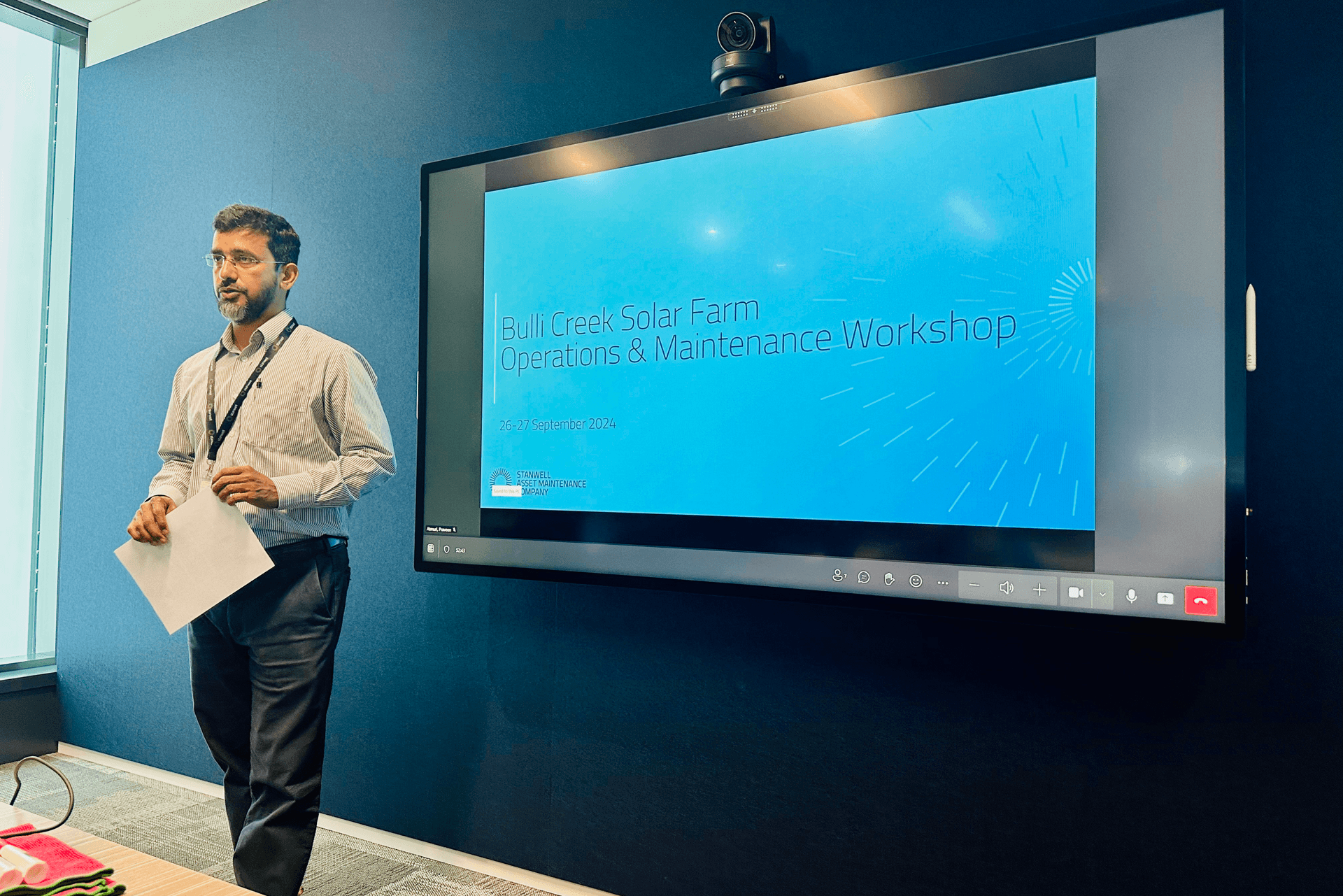 A man presenting a workshop standing in front of a screen